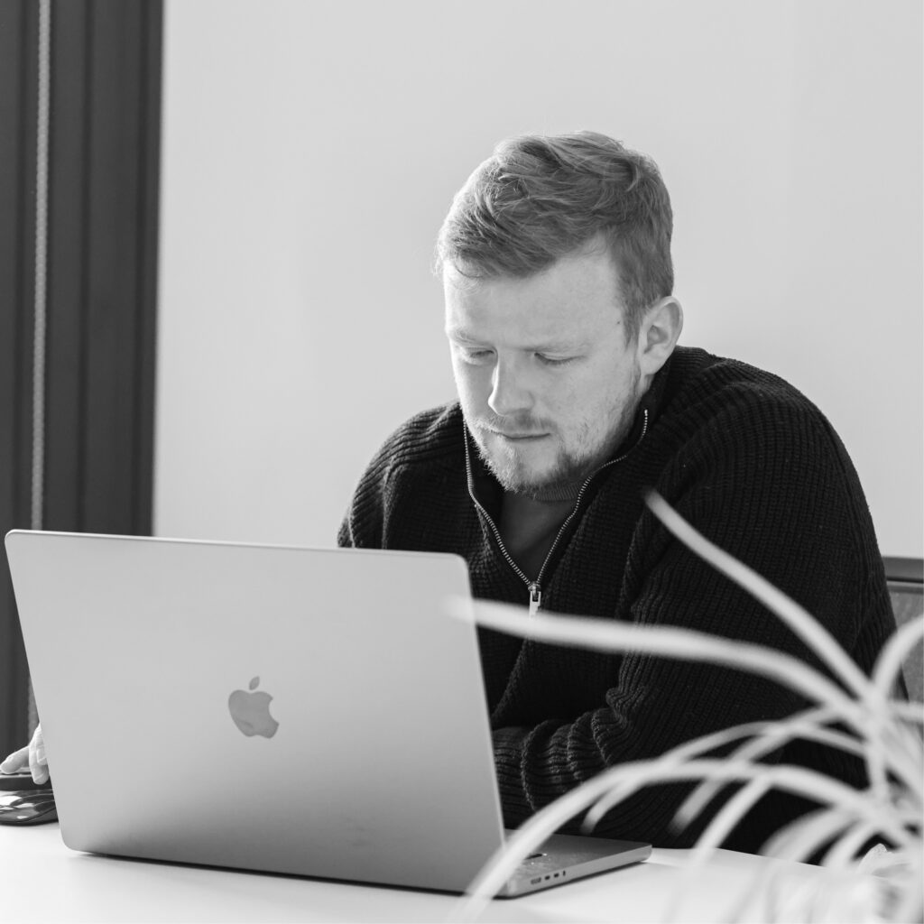 Marketer analysing paid search data on a MacBook