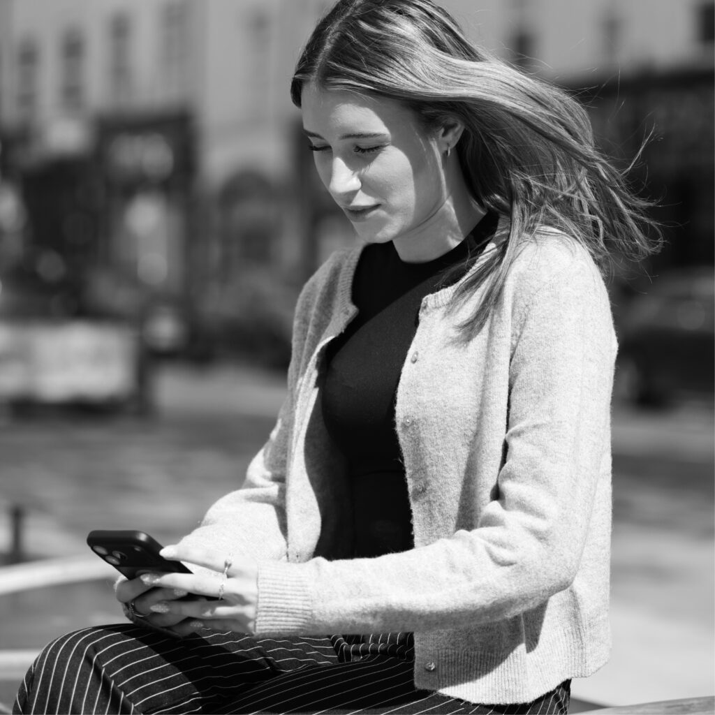 Marketing strategist watching video on mobile phone