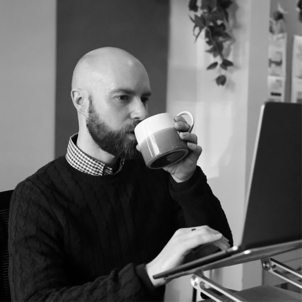 Marketer analysing data while working on laptop
