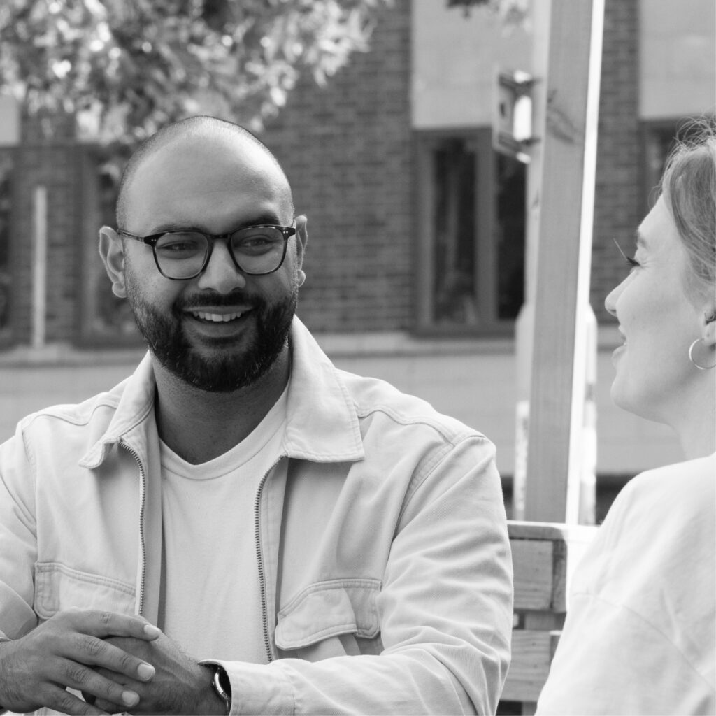 Two colleagues chatting and smiling
