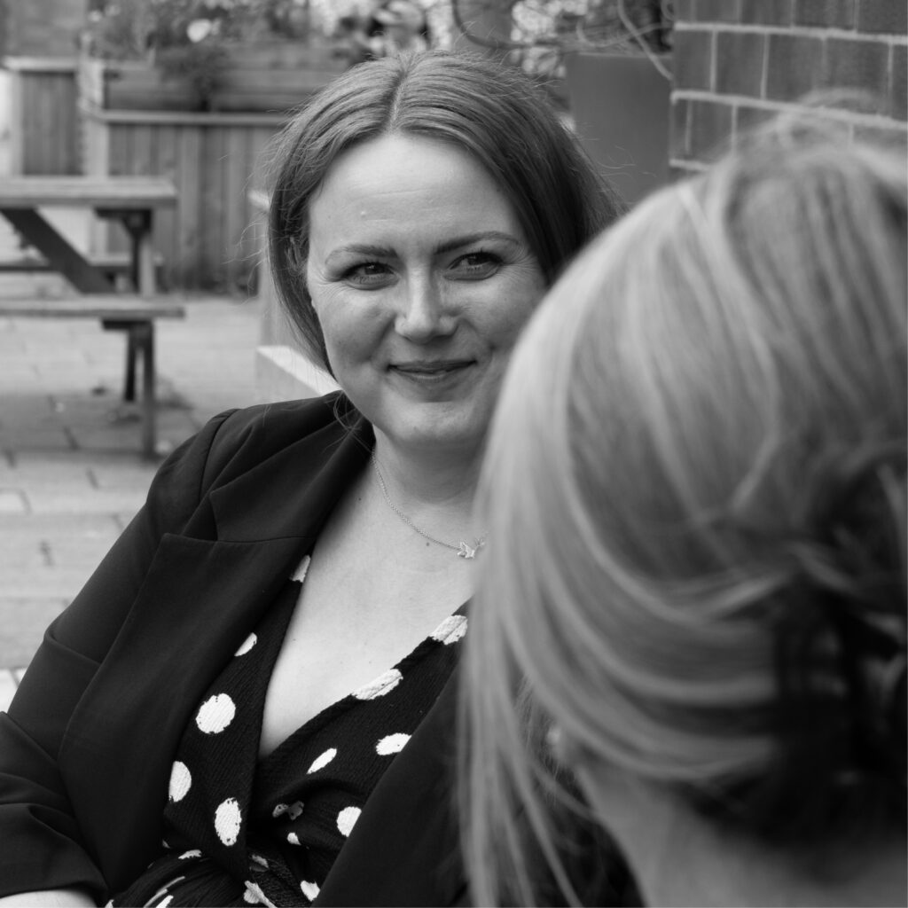 Photoshoot of our marketing team, Michelle, Sarah and Ellie strategising 