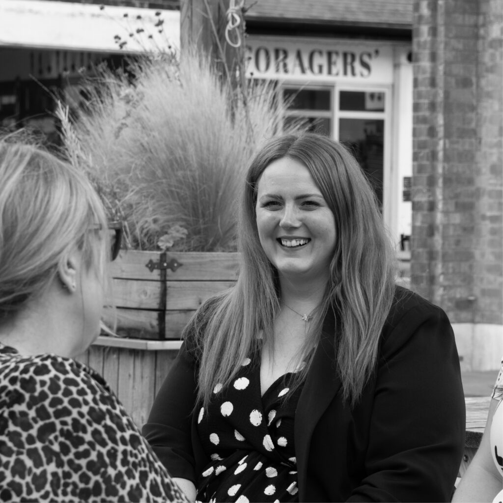 Photoshoot of our marketing team, Michelle, Sarah and Ellie strategising 